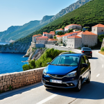**A scenic coastal road in Montenegro, with a rental car winding along the cliffs. In the background, the Adriatic Sea sparkles under a clear sky. Include a quaint village nestled on the hillside.** (This represents the freedom and flexibility of renting a car.)